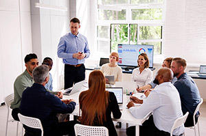 Corporate professionals using rental laptops for a training session