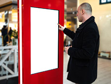 Interactive touch screen monitor at a trade show booth.